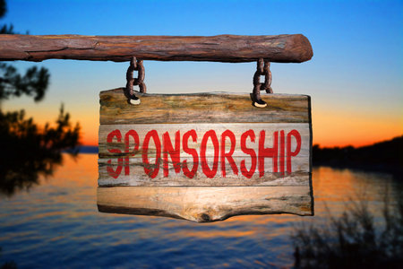 Sponsorship motivational phrase sign on old wood with blurred backgroundの写真素材
