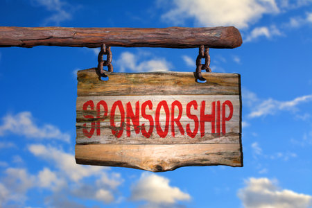 Sponsorship motivational phrase sign on old wood with blurred backgroundの写真素材