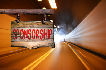 Sponsorship motivational phrase sign on old wood with blurred backgroundの写真素材