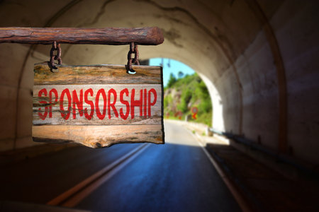 Sponsorship motivational phrase sign on old wood with blurred backgroundの写真素材
