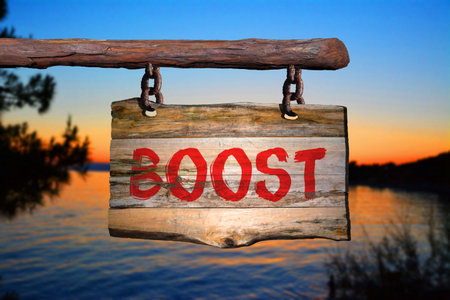 Boost motivational phrase sign on old wood with blurred backgroundの写真素材