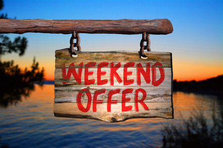 Weekend offer motivational phrase sign on old wood with blurred backgroundの写真素材