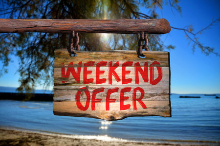 Weekend offer motivational phrase sign on old wood with blurred backgroundの写真素材