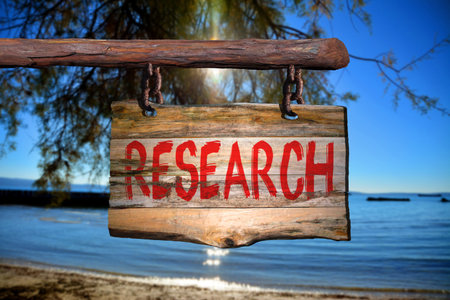 Research motivational phrase sign on old wood with blurred backgroundの写真素材