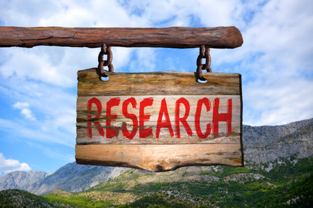 Research motivational phrase sign on old wood with blurred backgroundの写真素材