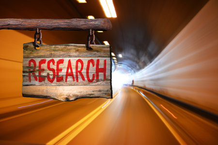Research motivational phrase sign on old wood with blurred backgroundの写真素材