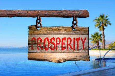 Prosperity motivational phrase sign on old wood with blurred backgroundの写真素材