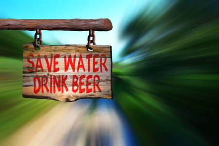 Save water drink beer motivational phrase sign on old wood with blurred backgroundの写真素材