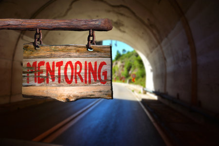 Mentoring motivational phrase sign on old wood with blurred backgroundの写真素材