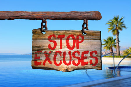 Stop excuses motivational phrase sign on old wood with blurred backgroundの写真素材