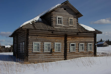 old village houses stand in the snow in the winterの写真素材