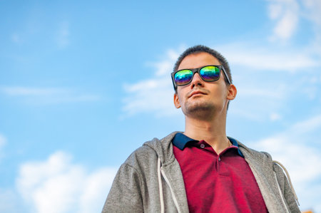 Portrait of a young man with glasses on the streetの写真素材