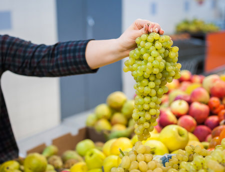 Caucasian girl buying fresh vegetables food products at the marketの写真素材