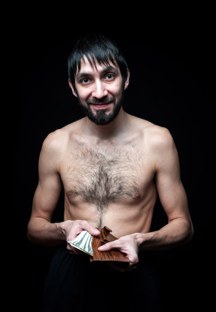Young man with banknotes on black backgroundの写真素材
