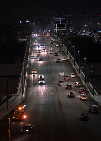 The car light trails on the highway in the night modern cityの写真素材