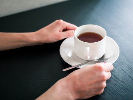 morning Cup of tea in the hands of a young womanの写真素材