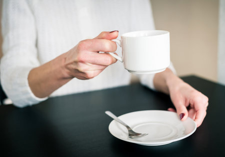 morning Cup of tea in the hands of a young womanの写真素材