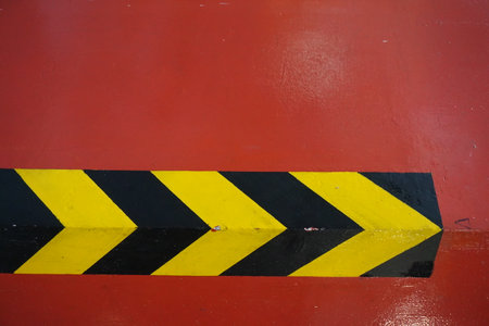 texture of red walls with black yellow markingsの写真素材