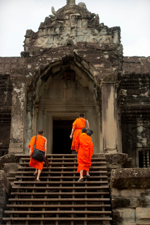 The monks go up the stairs of the temple complex of Angkor Wat in Cambodiaの写真素材