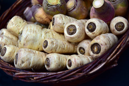 Close up of white parsnips in a wicker basketの写真素材