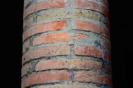 Close-up and detail of a brick red brick pillar