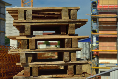 Wooden pallets are stacked on a construction siteの写真素材