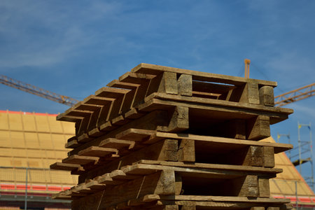 Wooden pallets are stacked on a construction siteの写真素材