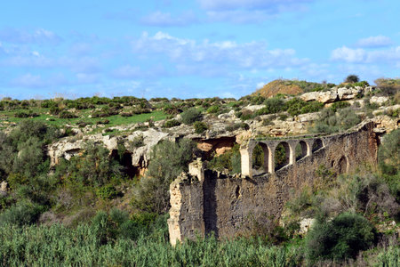 Typical landscape on Sicily with dilapidated ruin in the foreground between wild vegetationの写真素材