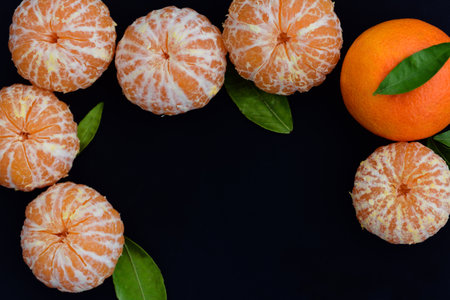 Dark background with text box framed by peeled fresh tangerines