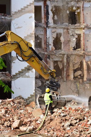 04/21/2020, in NeusÃ¤ss near Augsburg an old hotel is torn down and a worker sprays water against the dustのeditorial素材