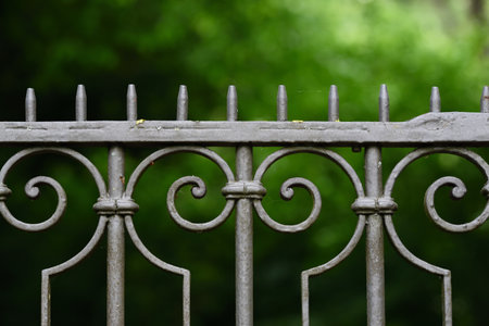 An old metal grille against a green background in natureの写真素材