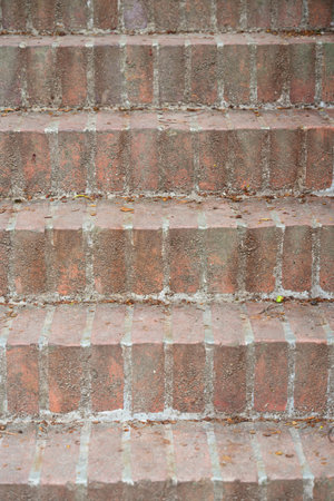 A portrait staircase, photographed from the front, made of old fired bricksの写真素材