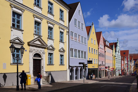 A street in "DonauwÃ¶rth", a small town with colorful historic houses, in Bavaria Swabia, against a blue skyのeditorial素材