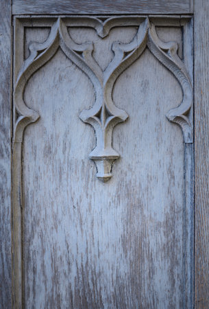 Background, texture and detail of an old blue wooden door with ornament and space for text, in portrait formatの写真素材