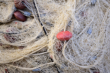 Close up, close up view and background of used brown fishing nets laid one on top of the otherの写真素材