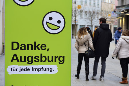 December, 06, 2021, in Augsburg in the pedestrian zone, a sign is placed in the Christmas environment, which asks to vaccinate against Corona.のeditorial素材
