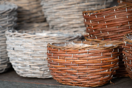 Various woven baskets made from natural materials are for sale on a shelfの写真素材