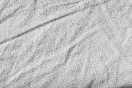 Close up, detail shot, texture and background of woven fabric that is a bit wrinkled. The fabric is light. There is space for text.の写真素材