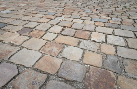 Background and texture of historic cobblestones made of stones that were individually hewn by hand. There is space for text.の写真素材