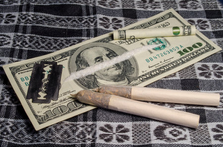 Money and drugs on the scarf with a bladeの写真素材