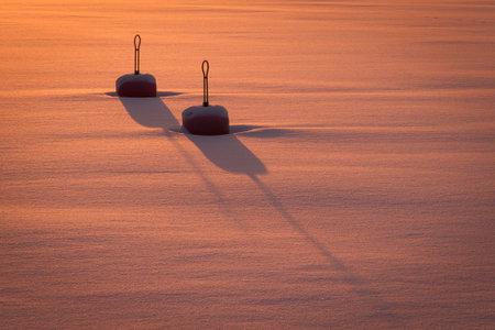 Winter image with two buoys in the frozen ocean.の写真素材