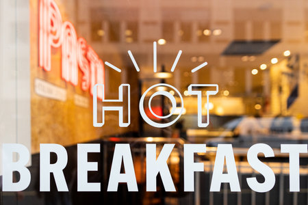 A restaurant window with a hot breakfast sign on itの写真素材