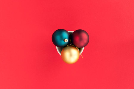 Golden, red and blue Christmas balls on a red background with space for text. Christmas and Xmas concept.Copy space. Top view. Flat layの写真素材