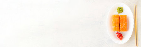 Banner with Philadelphia rolls. Japanese sushi food. Top view of sushi in white plate. Copy space....