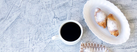 Banner with French breakfast with croissants and coffee. Two croissants and coffee served with...