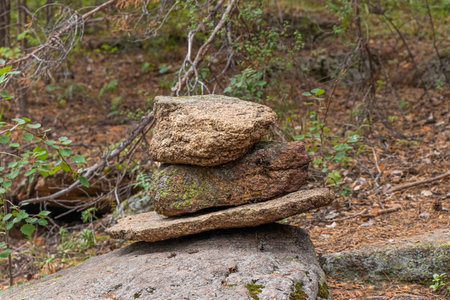 cairn. stone pyramid in the forest along the trail for the landmark of travelers. Soft focus