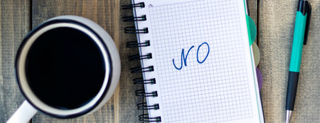 banner with word NO in notebook on the working table with cup of coffee and bun. Job recruiting concept. Flat layの写真素材