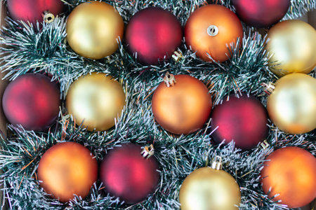 flat lay with gold, red and orange Christmas balls. Christmas background. New Year or Xmas concept. Top view. Close upの写真素材