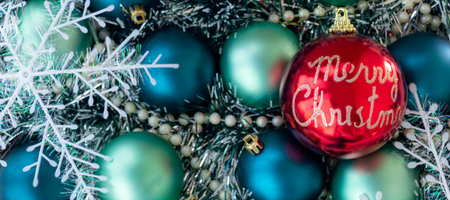 banner with flat lay with blue Christmas balls. Big red Christmas ball with words Merry Christmas. Christmas background. New Year or Xmas concept. Top view. Close upの写真素材