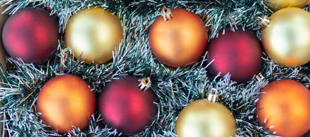 banner with flat lay with gold, red and orange Christmas balls. Christmas background. New Year or Xmas concept. Top view. Close upの写真素材